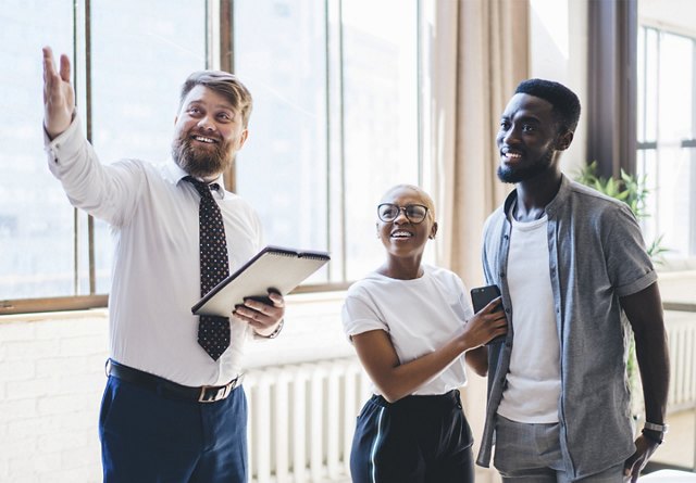 Young African American couple touring apartment with agent