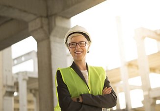 woman in construction site with yellow safety vest