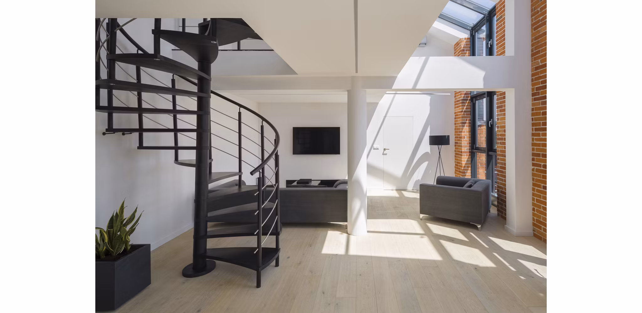 Loft apartment with open brick and a spiral staircase