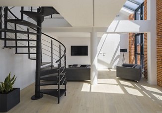 Loft apartment with open brick and a spiral staircase
