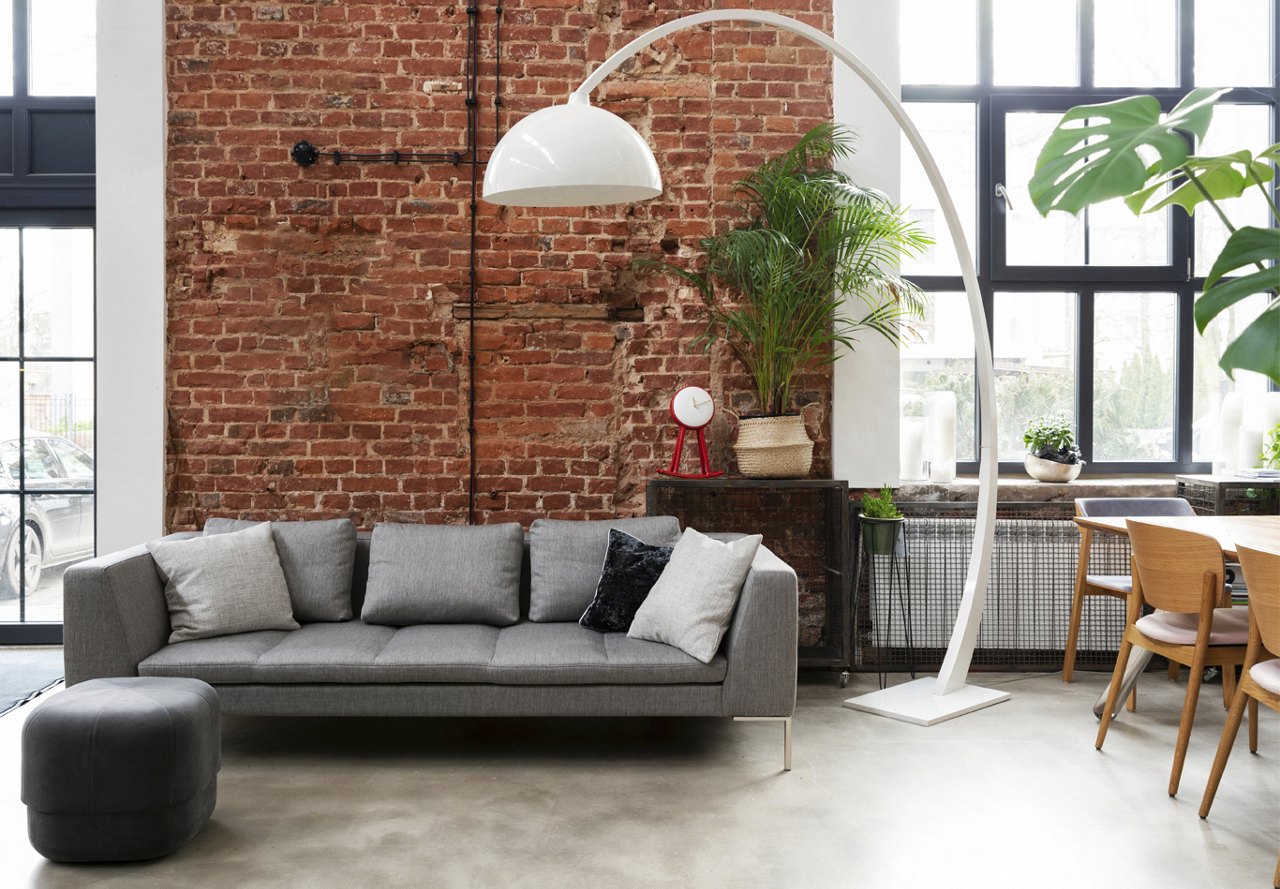 Loft apartment with a brick wall background and greenery