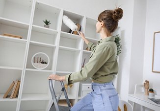 girl dusting shelf