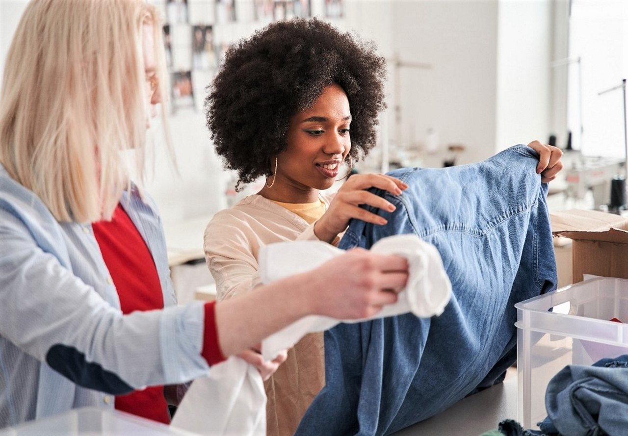 woman looking at clothes at donation center