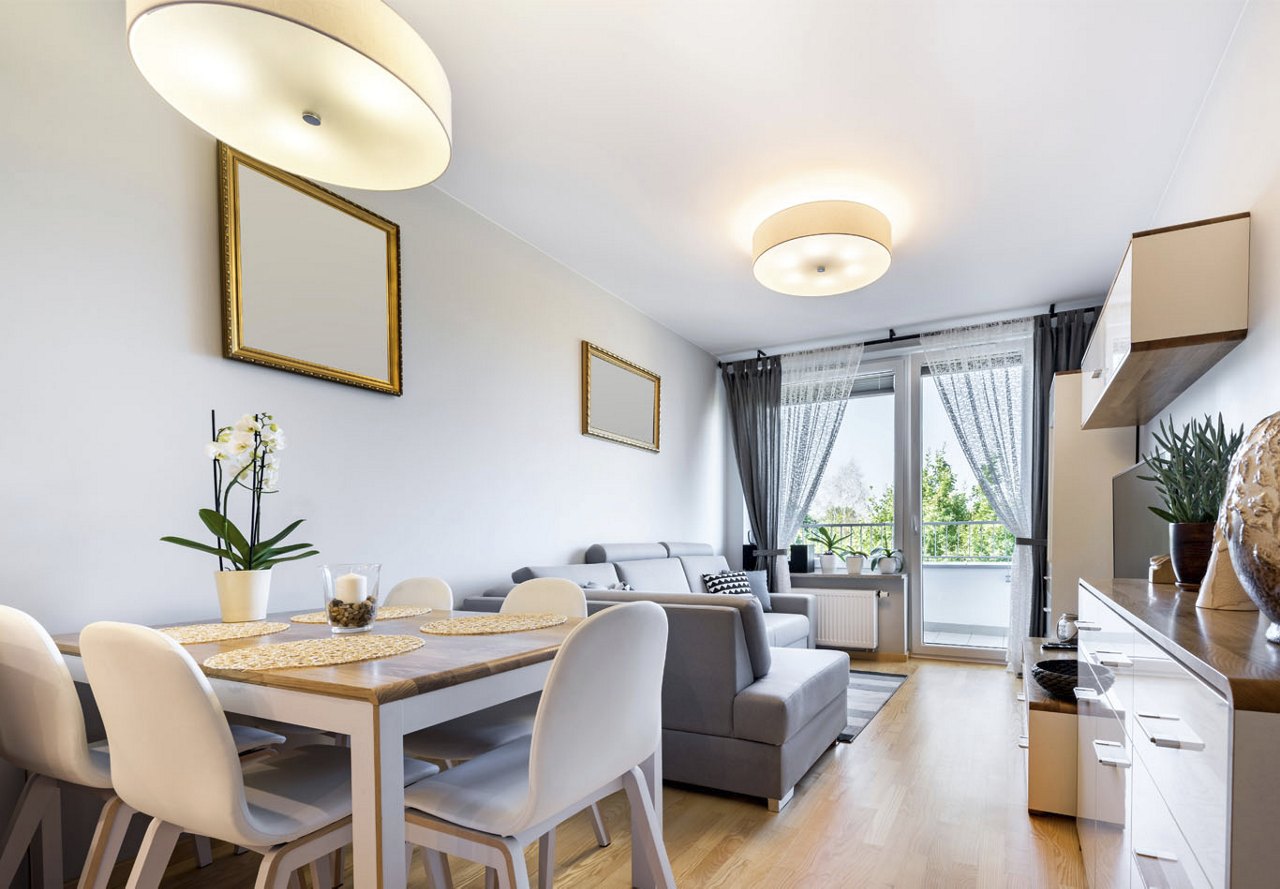 A modern apartment designed with an open and airy feel, filled with natural light throughout. The simplistic decor enhances the small space, creating a cozy yet stylish environment.