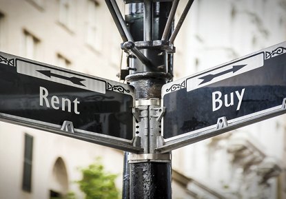 Street sign featuring the words "Rent" and "Buy," each with a black arrow pointing in opposite directions, set against the backdrop of a modern building.