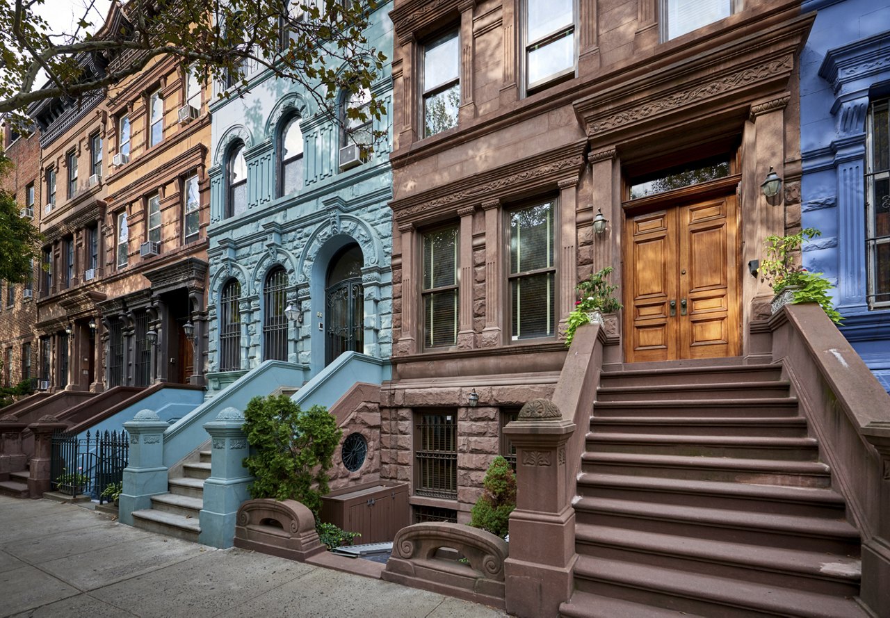 A view of historic homes in the city, featuring colorful brownstones and beautiful architecture, highlighting the charm and character of the neighborhood.