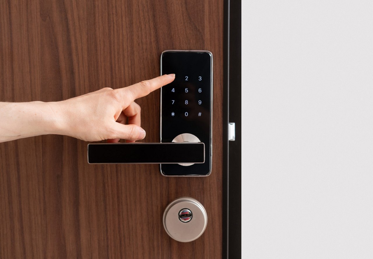 Person entering a code on a keypad to unlock a wooden door with a silver lock, showcasing smart home technology.