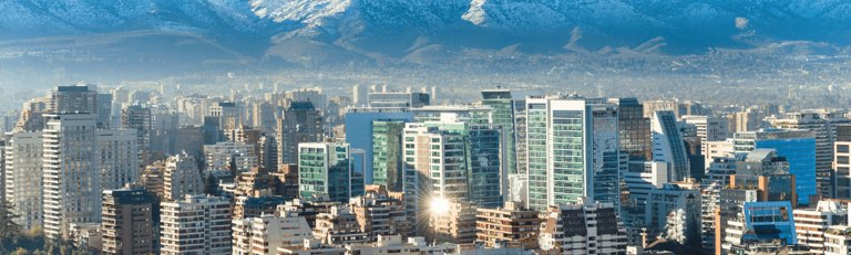 Scenic view of a Chilean cityscape, characterized by a harmonious blend of modern skyscrapers and historical buildings, set against the dramatic backdrop of distant mountains. The skyline reflects Chile&amp;apos;s unique combination of urban development and natural beauty, under a clear and expansive sky.