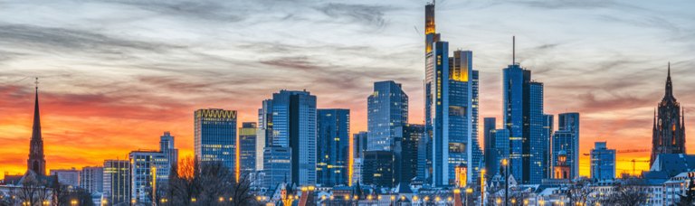 Panoramic view of a picturesque German townscape, showcasing traditional half-timbered houses with distinct gabled roofs and colorful facades, aligned along a peaceful, tree-lined street.