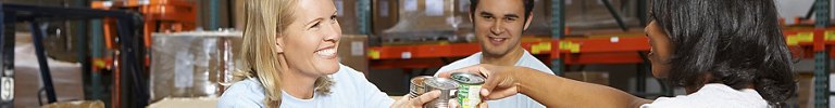 Volunteers Collecting Food Donations In Warehouse