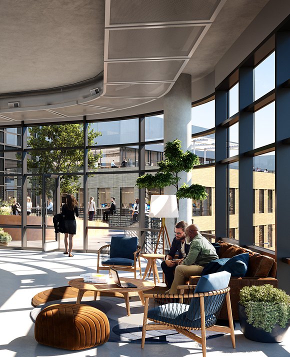 Modern office lobby with high ceilings and large windows, featuring contemporary furniture and two individuals engaged in conversation.