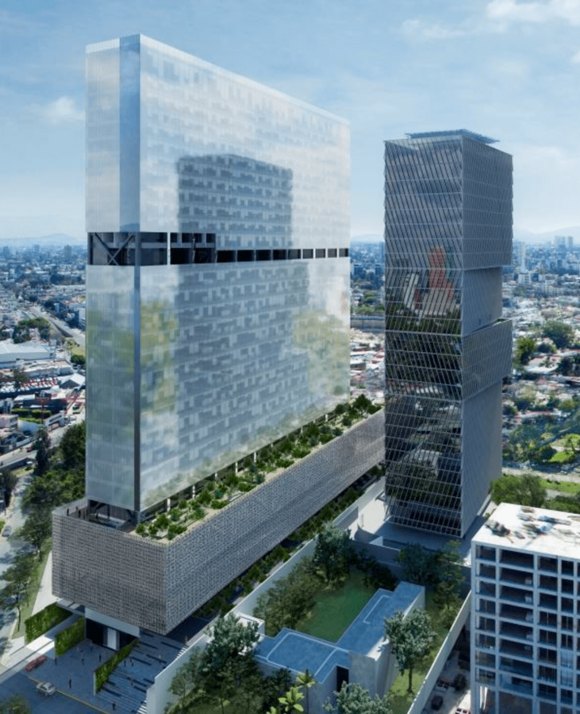 Striking view of Mexico City, featuring two tall, modern skyscrapers dominating the skyline. The buildings are set against the backdrop of the expansive city, illustrating the blend of contemporary architecture and the urban sprawl of Mexico's capital.