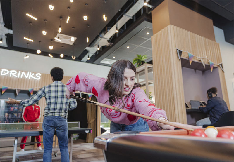 Young woman playing pool