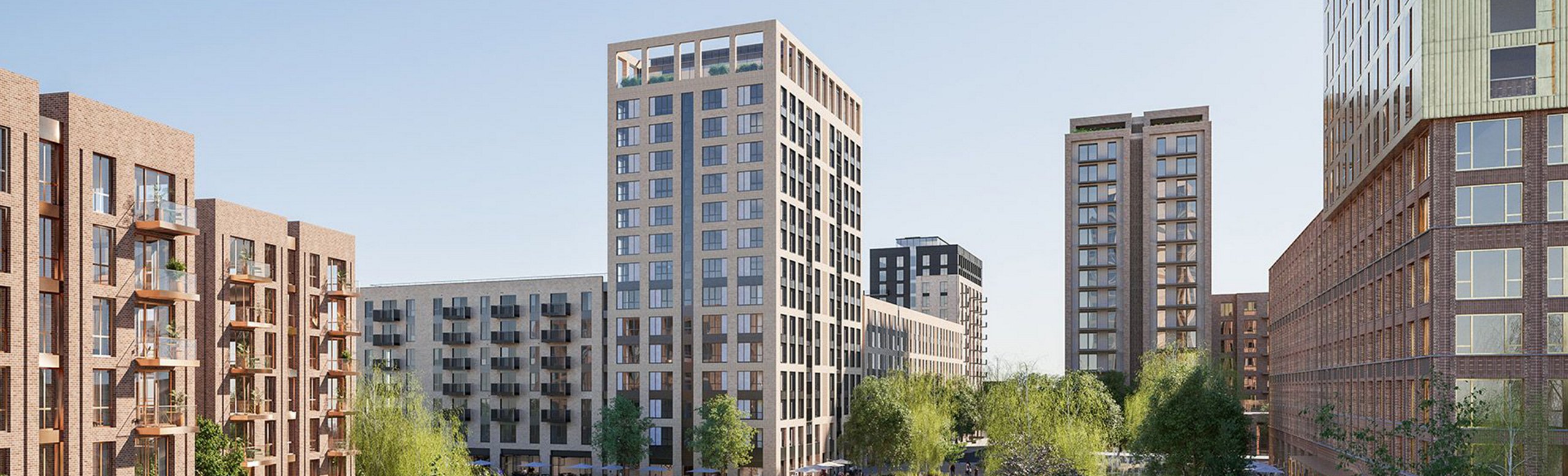 Panoramic view of a new urban development featuring several brick residential buildings with a prominent high-rise in the center.