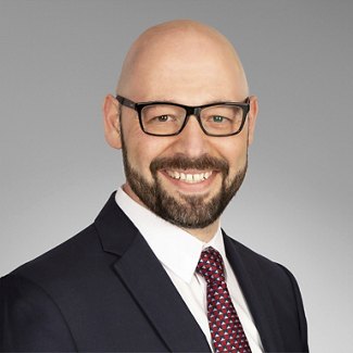 Greystar employee in black suit and red tie