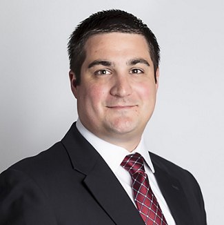 Greystar employee in black suit and red tie