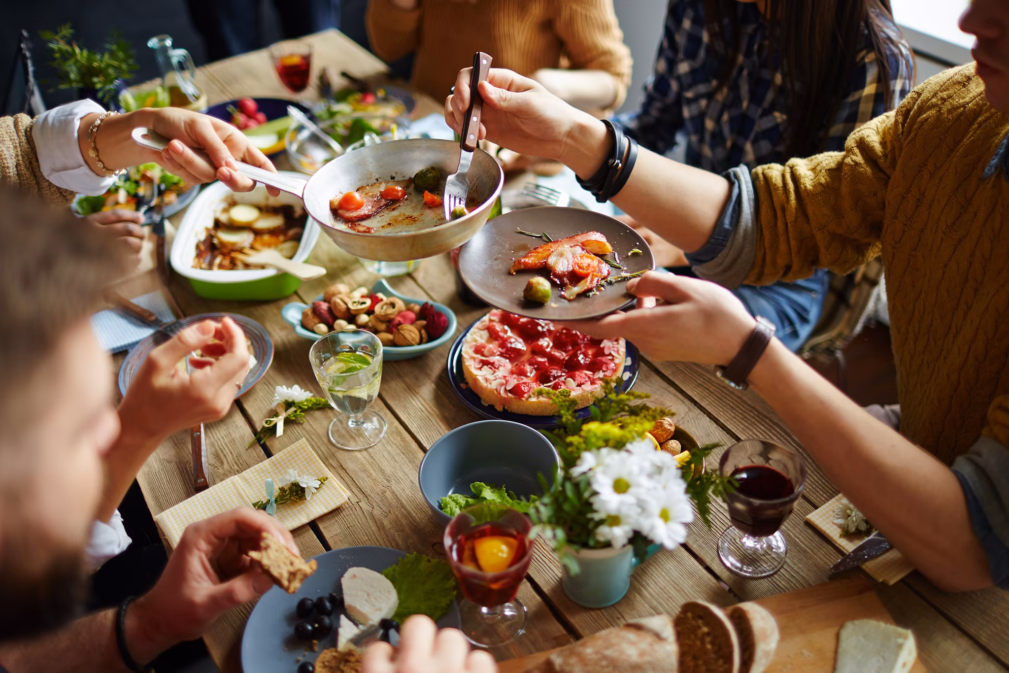 People sitting at dining table and eating