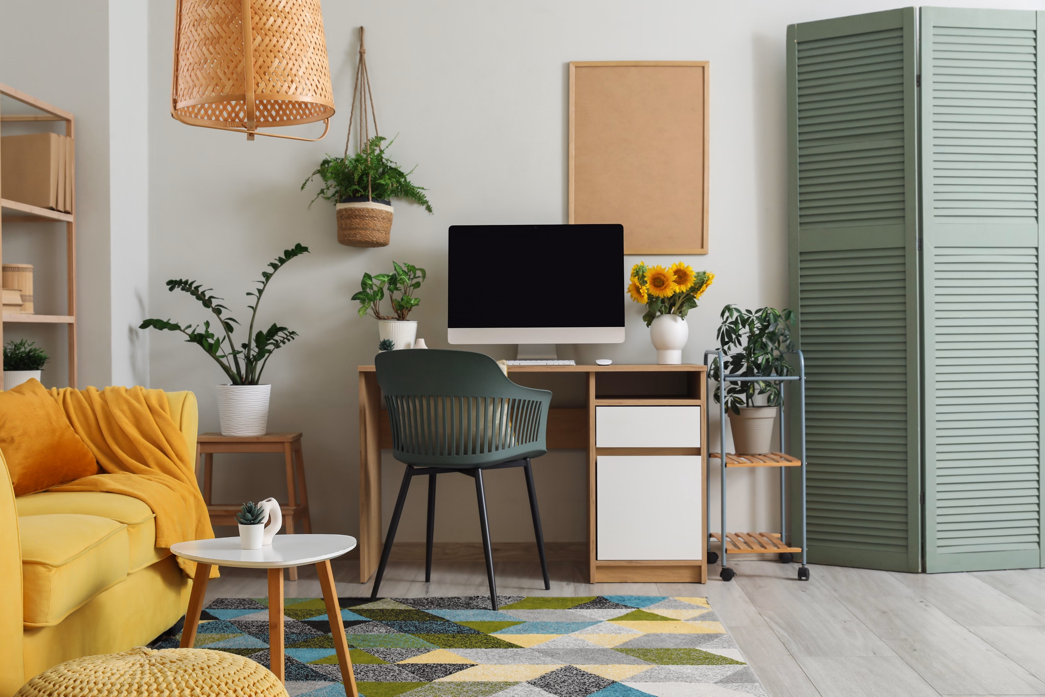 Interior of living room with workplace and plants