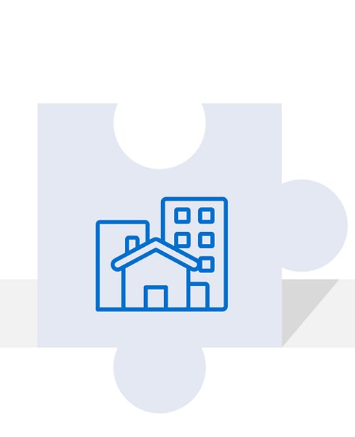 Icon displaying a simple representation of residential and commercial buildings on a puzzle piece, symbolizing community development or real estate.