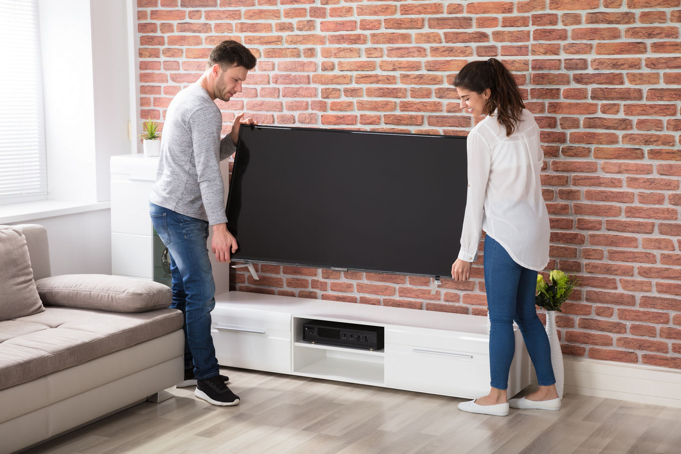 Couple Moving Television into an Apartment | Blog | Greystar