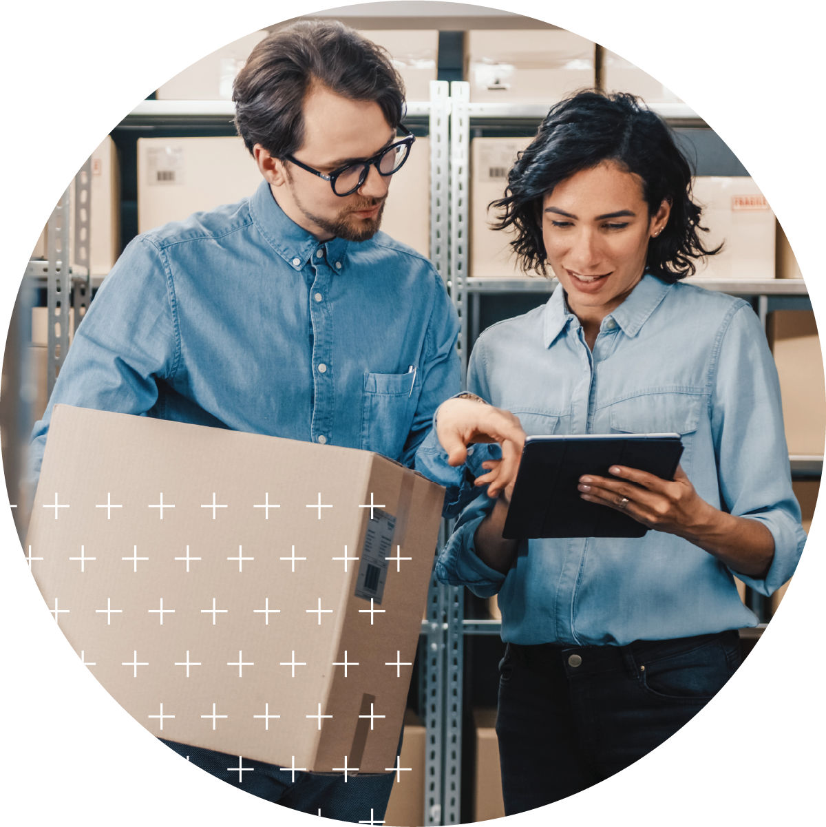 Small business owners in warehouse holding box and tablet