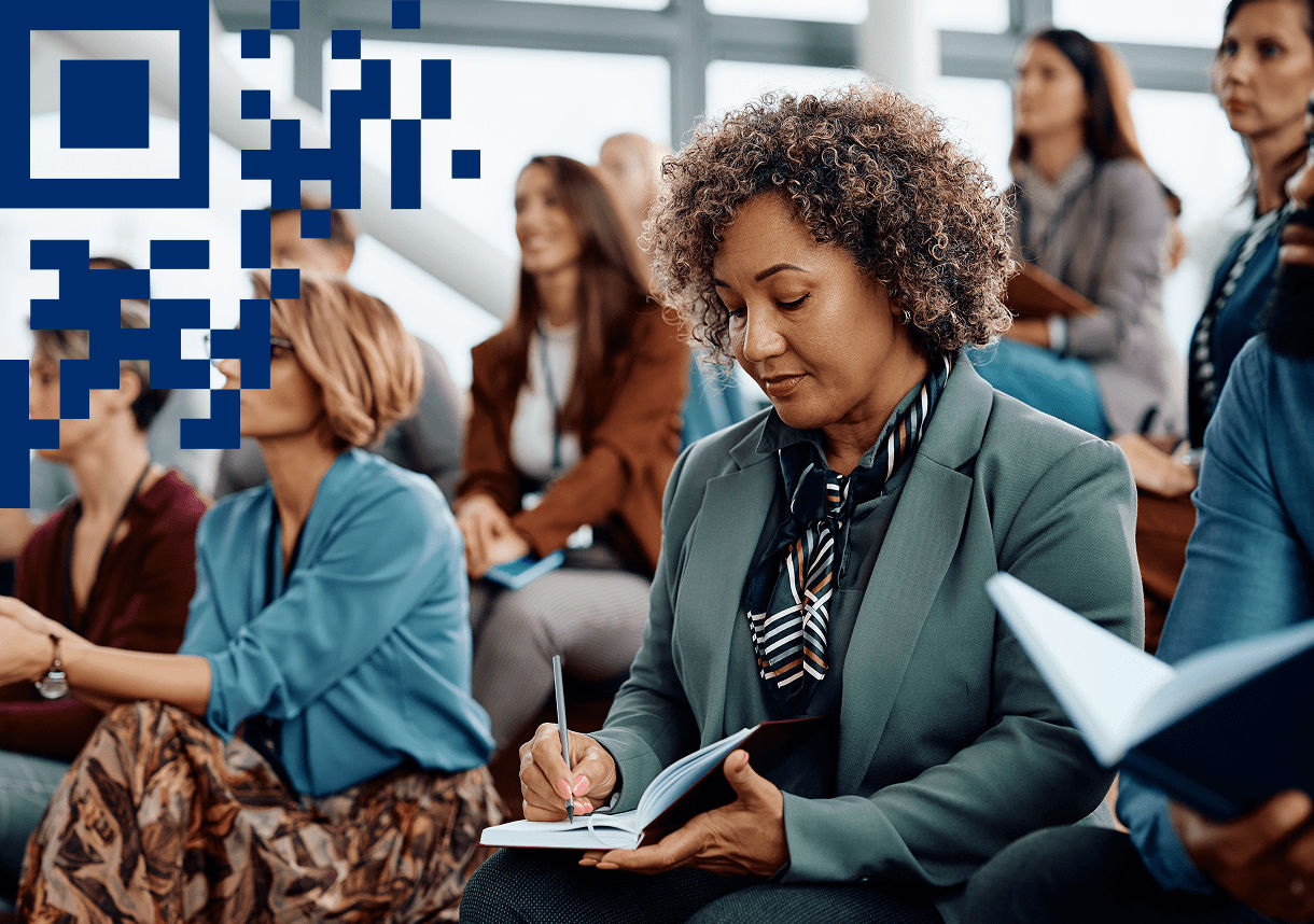Conference attendee taking notes with 2D pattern overlay in left corner