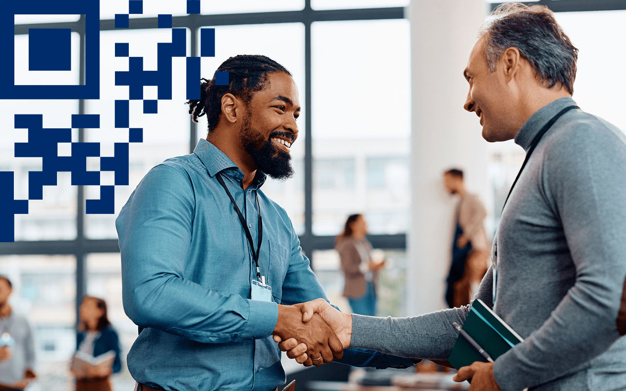 Conference attendees shaking hands with 2D carrier overlay in left corner