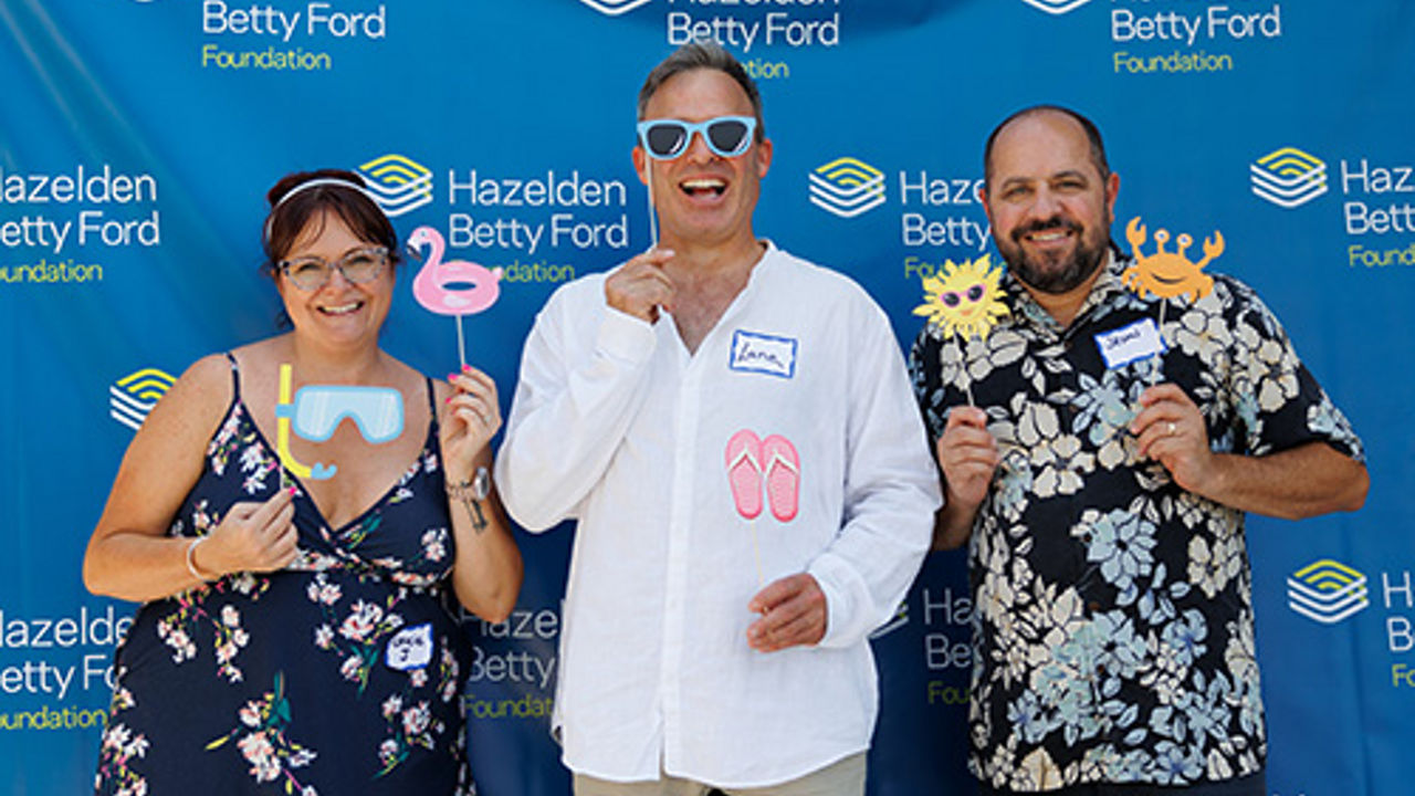 Ice-cream social attendants posing with fun props