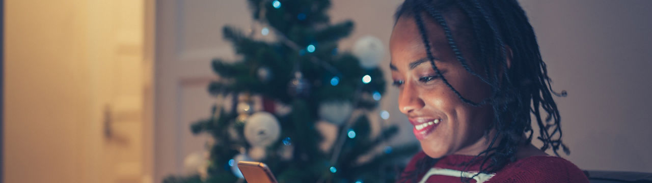 African American woman online Christmas shopping at home