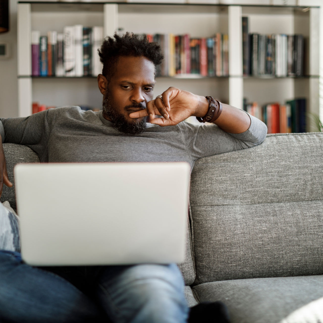 Young man watching movie on laptop at home