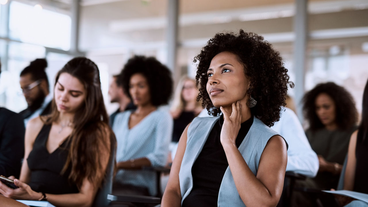 Shot of a businesswoman listening intently during a conference