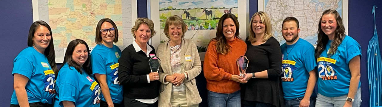 Colorado Children’s Program 20th Anniversary Honorees (fourth from left) MaryPat Woodard, Sandy Cowden, Michael Maassel and Tabitha Miller (Harmony Foundation) pictured with staff