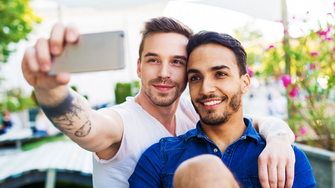 Couple traveling around Europe and exploring capital cities and places of interest. Gay couples and friends travel to attractive destinations and making new friendships and relationships with local gay communities