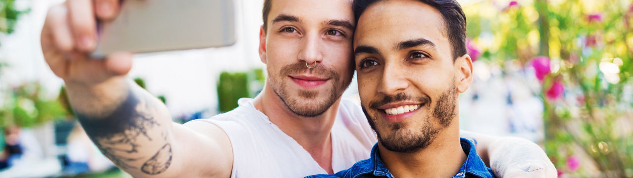 Couple traveling around Europe and exploring capital cities and places of interest. Gay couples and friends travel to attractive destinations and making new friendships and relationships with local gay communities