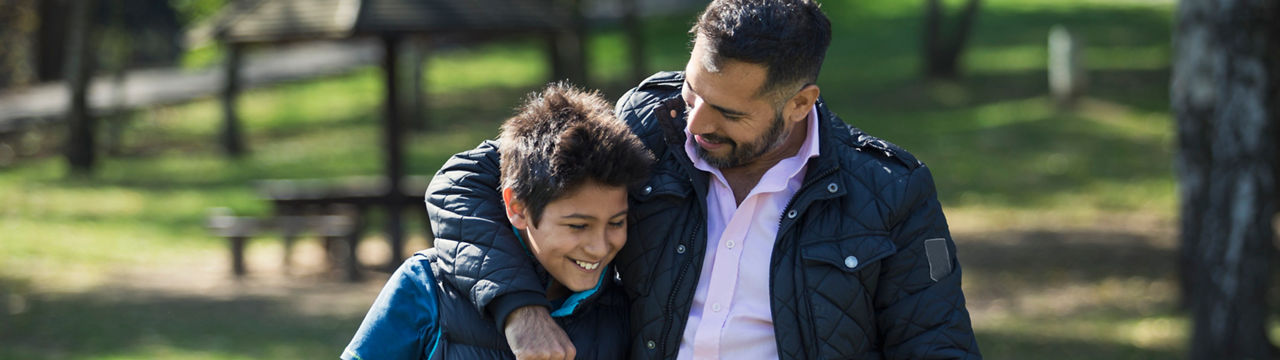 Father and son in public park