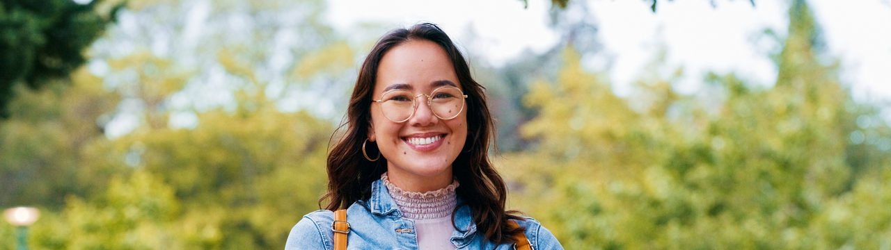 Woman, university student and books in portrait, outdoor and pride for learning, knowledge or happy in park. Girl, Japanese person and smile for scholarship, education and studying at college campus