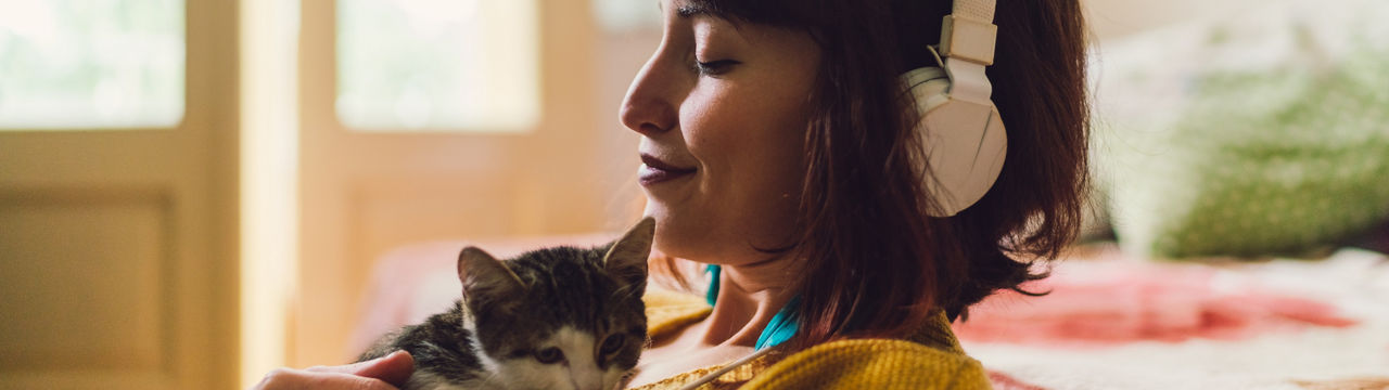 Female with cat at home relaxing during the weekend