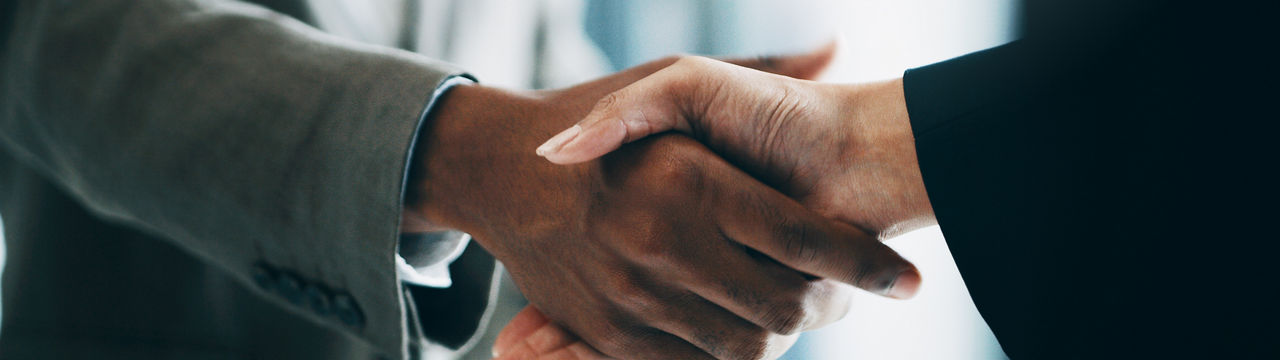 Closeup shot of two unrecognizable businesspeople shaking hands in an office