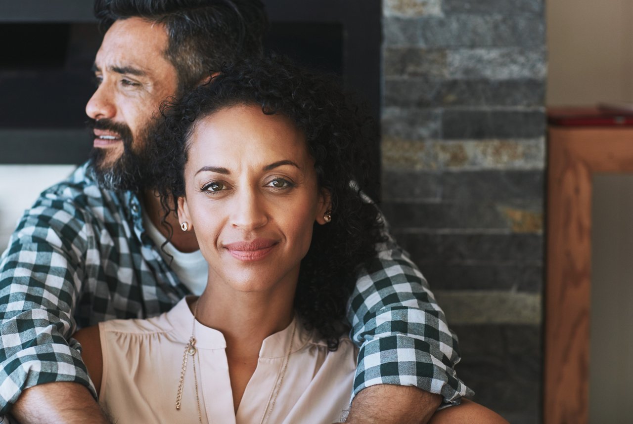Portrait of a happy laid-back couple relaxing together at home