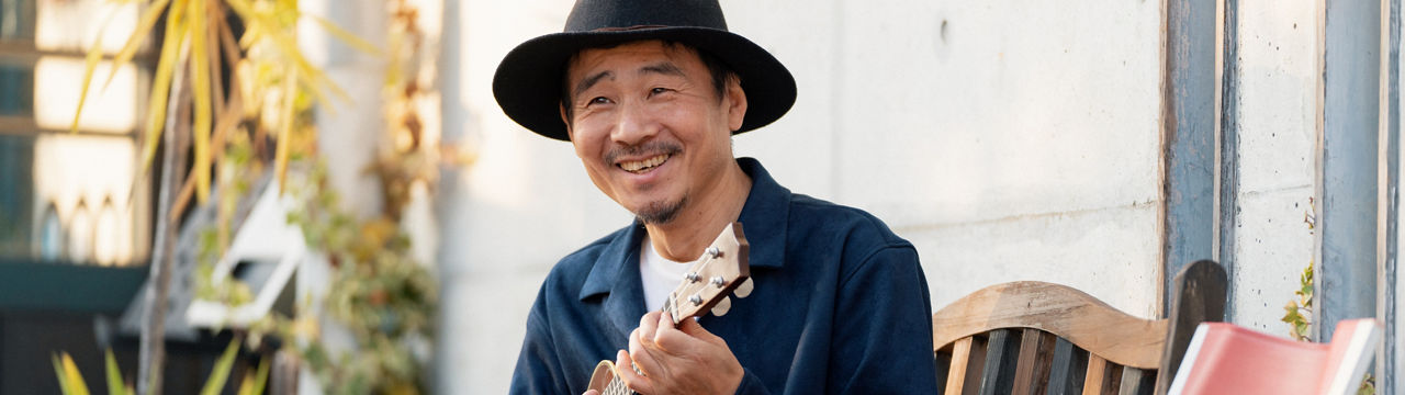 Portrait of a happy looking mature man with an ukulele
