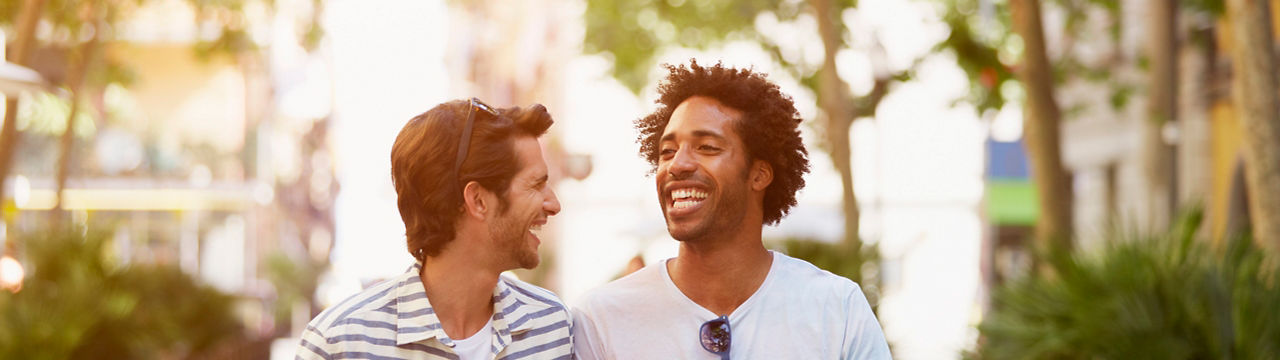 Happy multi-ethnic male friends walking outdoors