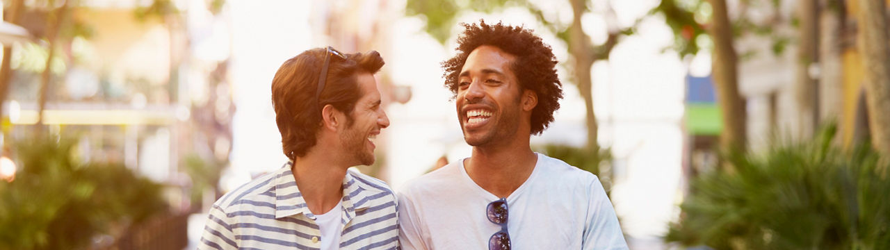 Happy multi-ethnic male friends walking outdoors