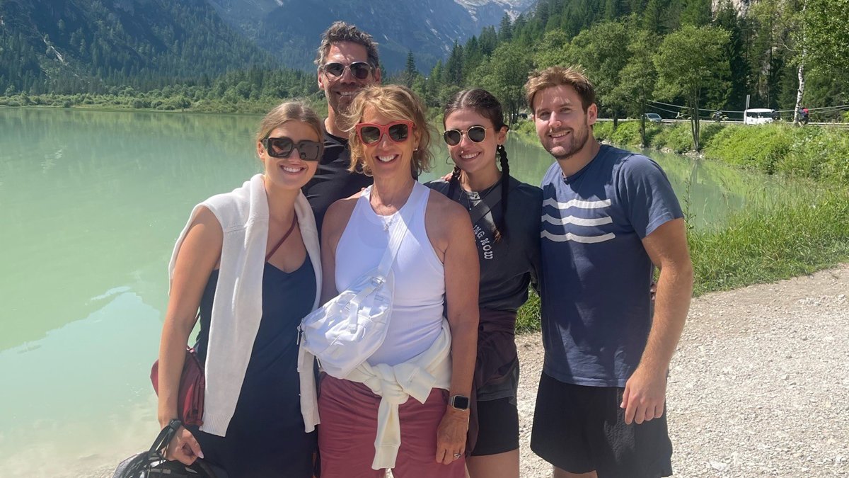 The Logan family standing in front of a pond in a forest