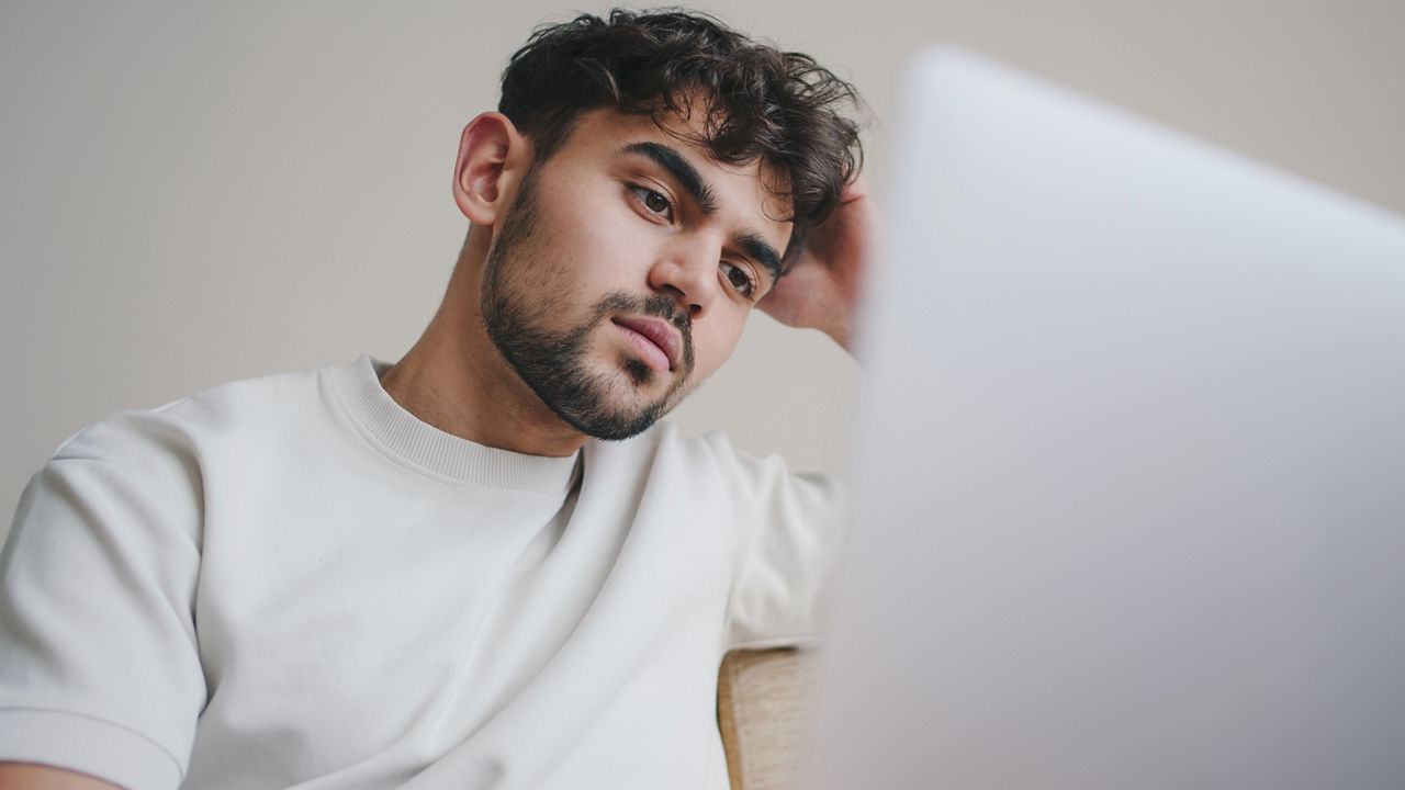 Young man student watching webinars