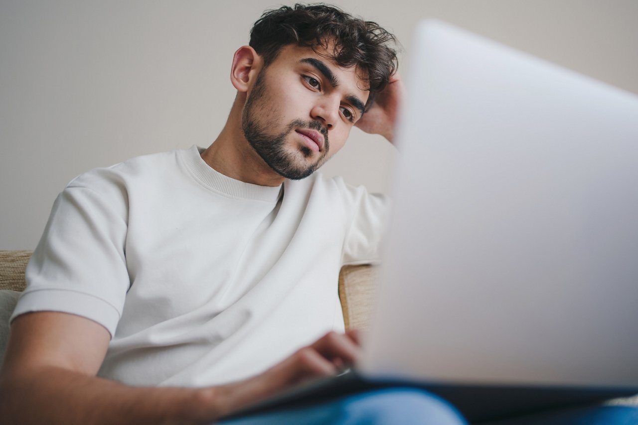 Young man student watching webinars