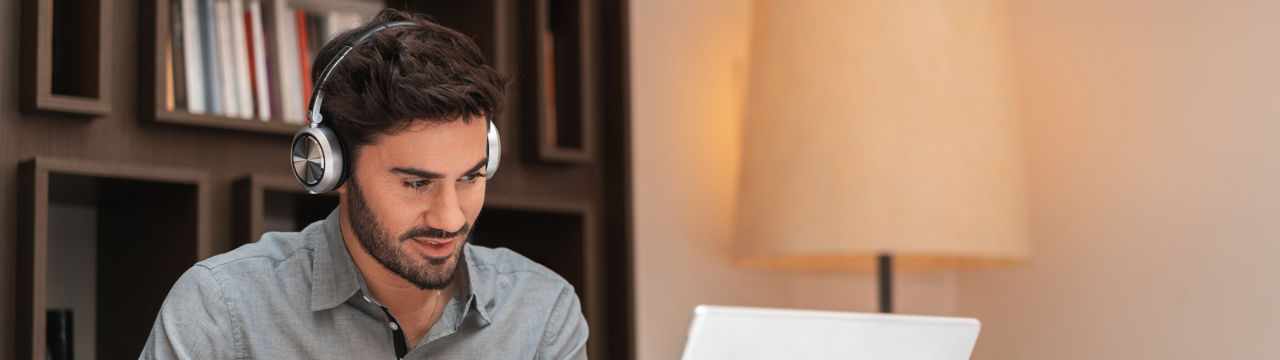 Male with headphones on laptop