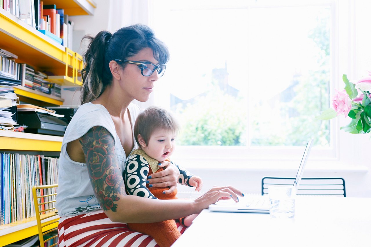 Mother and baby working on laptop 