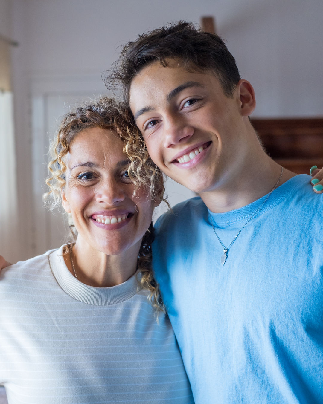 Portrait of grateful teenager man hug smiling middle-aged mother show love and care, thankful happy grown-up son in embrace cheerful mom, enjoy weekend family time at home together, bonding concept