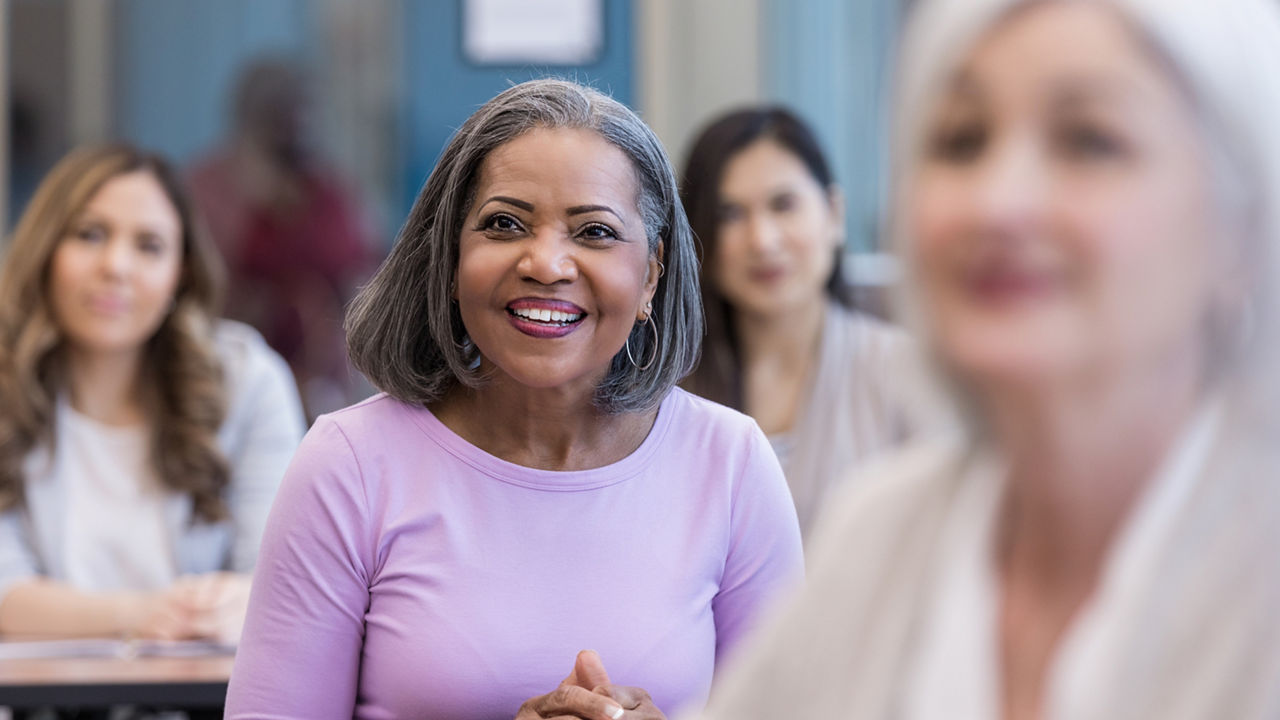 A multi-ethnic group of women attend a seminar at the local library about job opportunities in the local area.