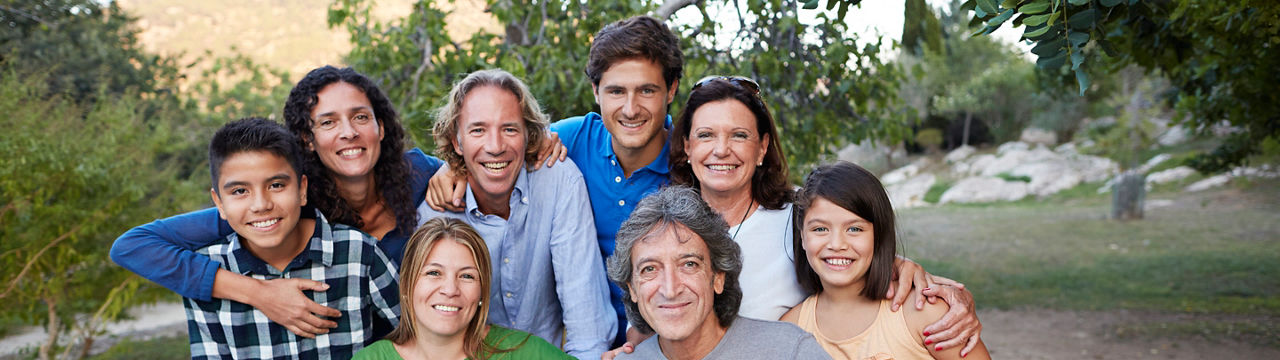 Group photo of multigenerational family after big dinner in garden